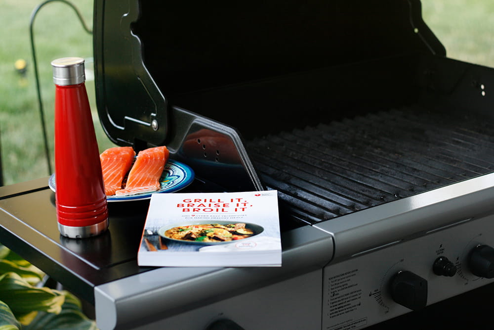 grill cookbook and water bottle with salmon