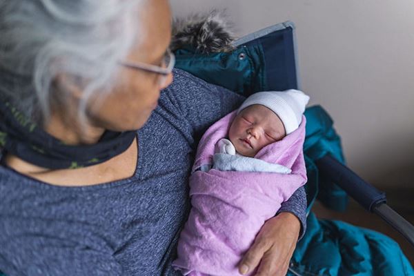 Grandmother holding infant grandchild