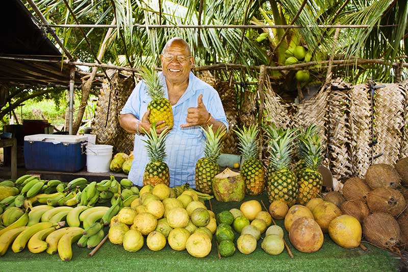 Man selling fruit at a roadside stand