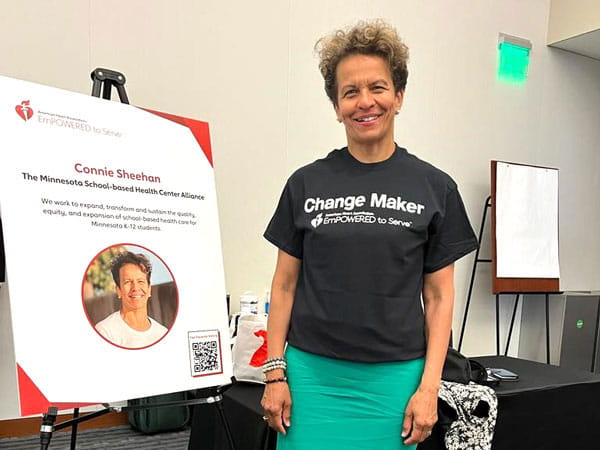 EmPOWERED to Serve Minnesota Business Accelerator 2022 finalist, Connie Sheehan, at her table