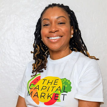 headshot of Ashley Drakeford wearing a Capital Market t-shirt against a white background