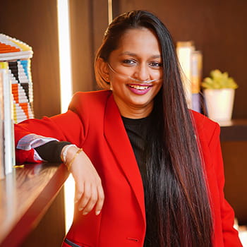 headshot of Shavini Fernando next to a bookcase