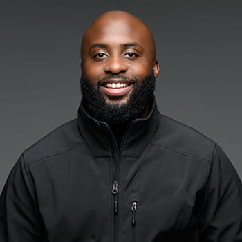headshot of Kwamane Liddell against a grey background