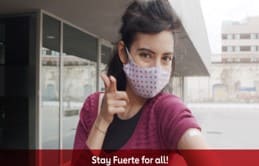 Masked Woman holding her thumb up  Stay Fuerte for all!
