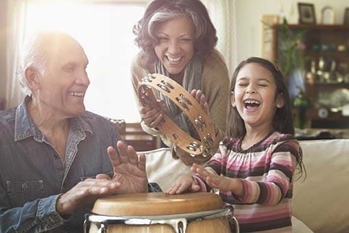 Grandparents and granddaughter playing music