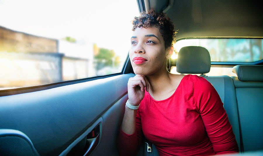 peaceful woman looks out car window