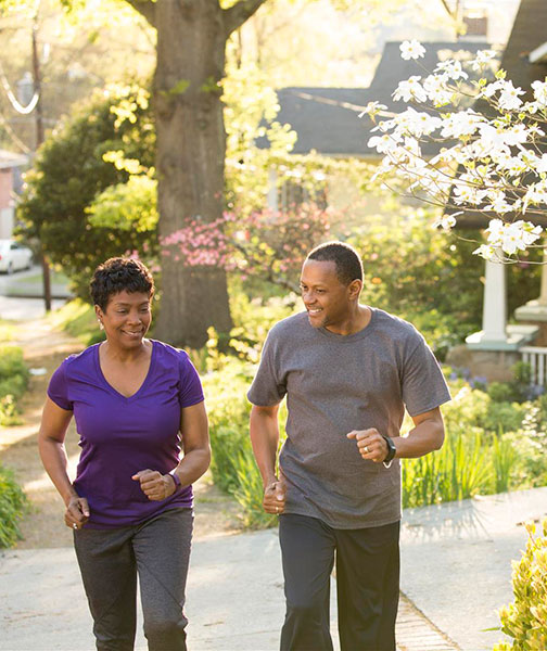 couple walking on sidewalk couple walking on sidewalk