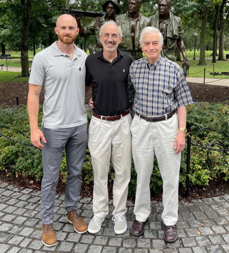 Dr. J. Michael Gaziano (center) of the Million Veteran Program is flanked by his son, Dante Gaziano, and father, Dr. Dominic Gaziano in the summer of 2022 at the Vietnam Veterans Memorial in Washington. (Photo courtesy of J. Michael Gaziano)