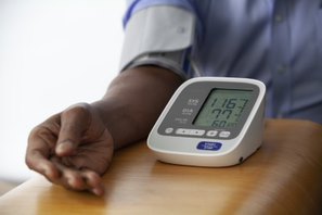person using a blood pressure cuff