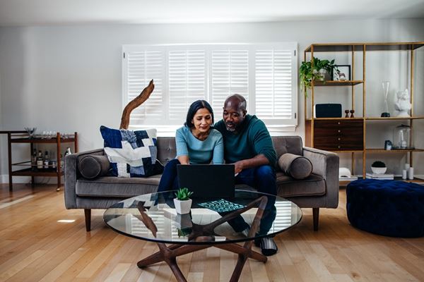 Couple on the sofa working on laptop