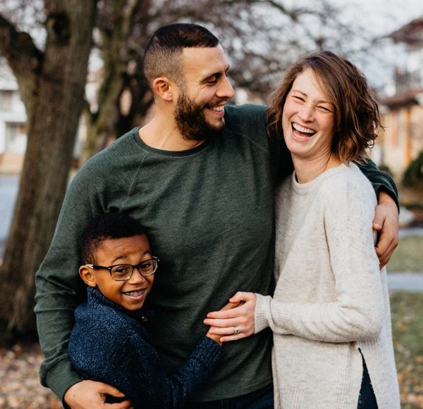 Family Standing in Front of a Tree