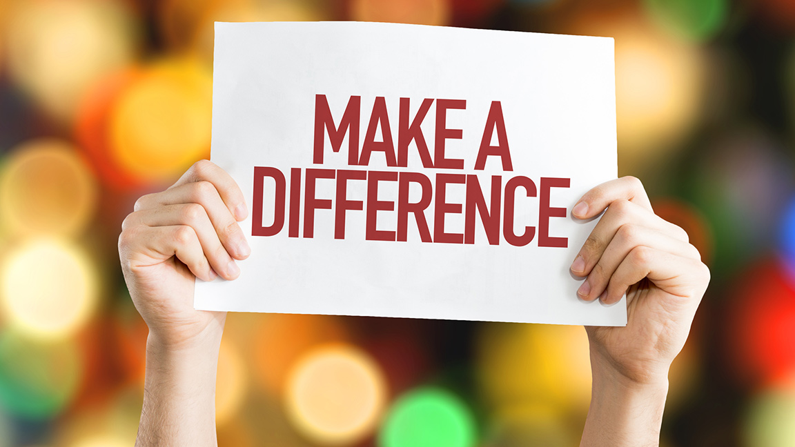 Hands holding up a sign that says Make A Difference