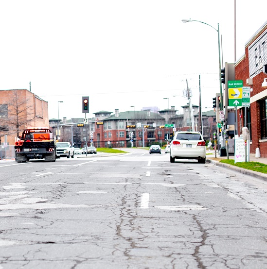 A street with buildings and vehicle traffic