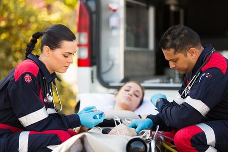 paramedics checking overdose patient at back of ambulance paramedics checking overdose patient at back of ambulance