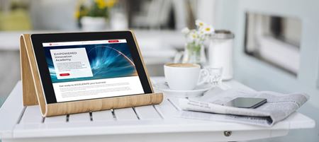 a digital tablet, newspaper, smartphone and coffee cup are sitting on a white table inside a bright living space a digital tablet, newspaper, smartphone and coffee cup are sitting on a white table inside a bright living space