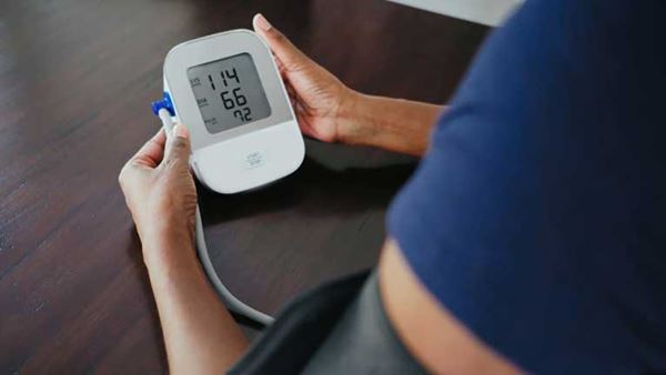 closeup image of person taking their blood pressure